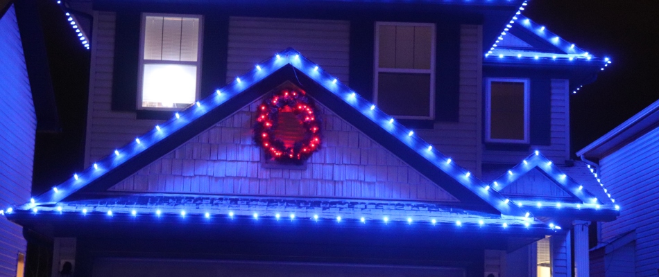 Blue led holiday lights hung around roof perimeter in Killarney, AB.