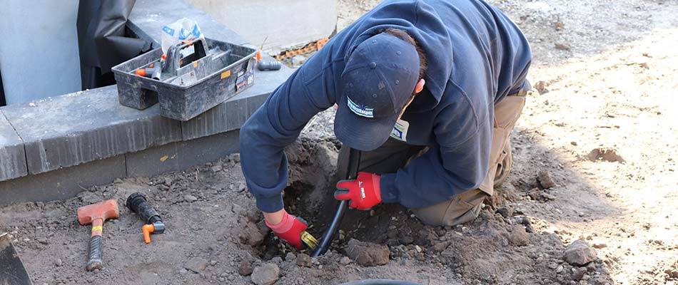 Irrigation technician installing a new system in Langdon, AB.