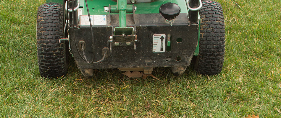 Overseeding machine servicing lawn in Aspen Woods, AB.