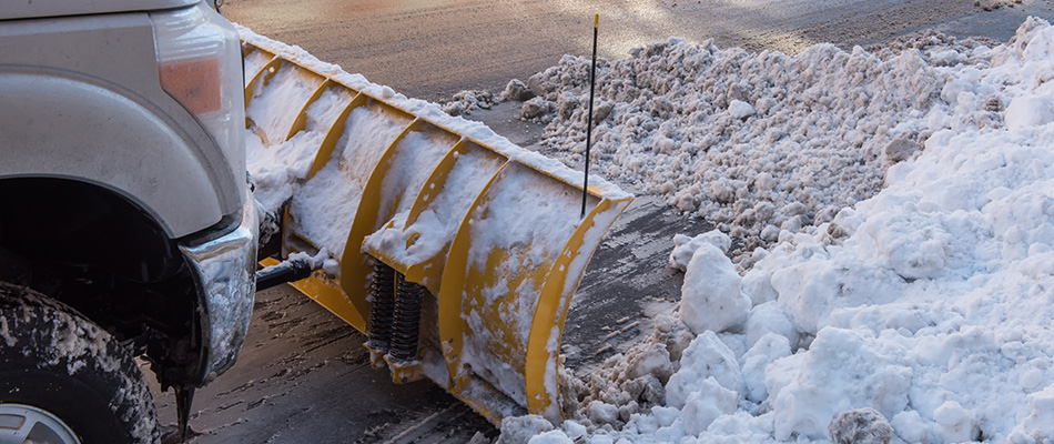 Icy road being plowed in Calgary, AB.