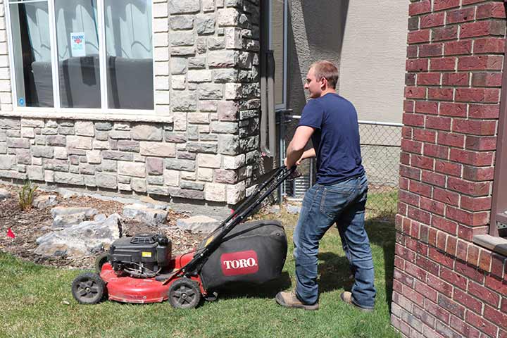 Lawn mowing services at a home in Calgary, Alberta.